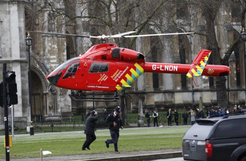 An air ambulance lands in Parliament Square during an incident on Westminster Bridge in London, Britain March 22, 2017. (photo credit: REUTERS)