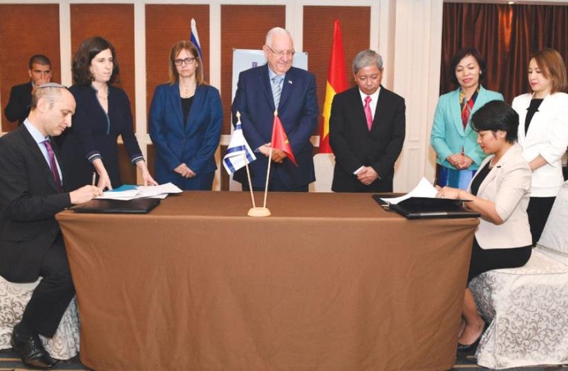 PRESIDENT REUVEN RIVLIN and Ambassador to Vietnam Meirav Shahar (third left) attend yesterday’s signing ceremony in Hanoi.  (photo credit: KOBI GIDEON/GPO)