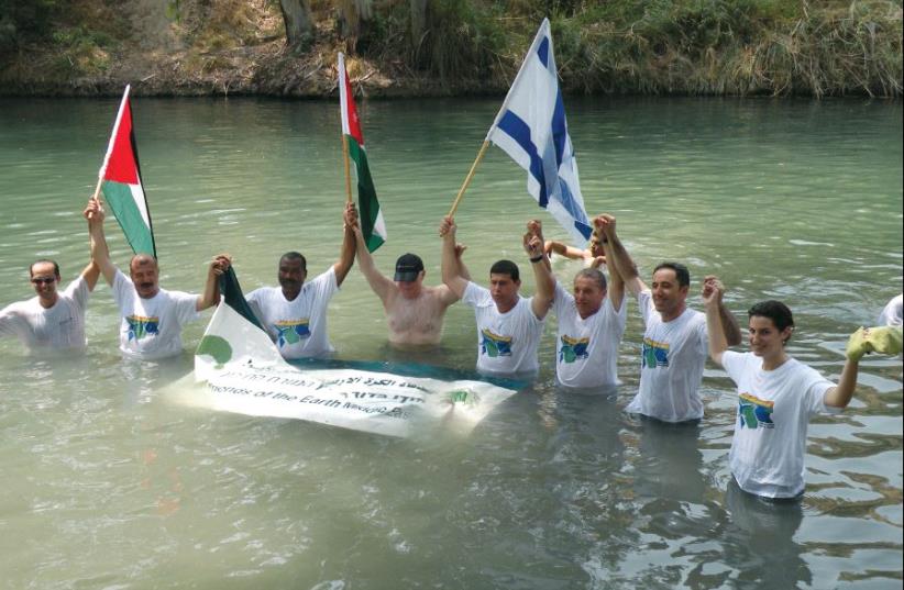 Israeli, Palestinian and Jordanian mayors and municipal representatives participate in an event in the lower Jordan River, to call on the two governments to rehabilitate the river (photo credit: ECOPEACE MIDDLE EAST)