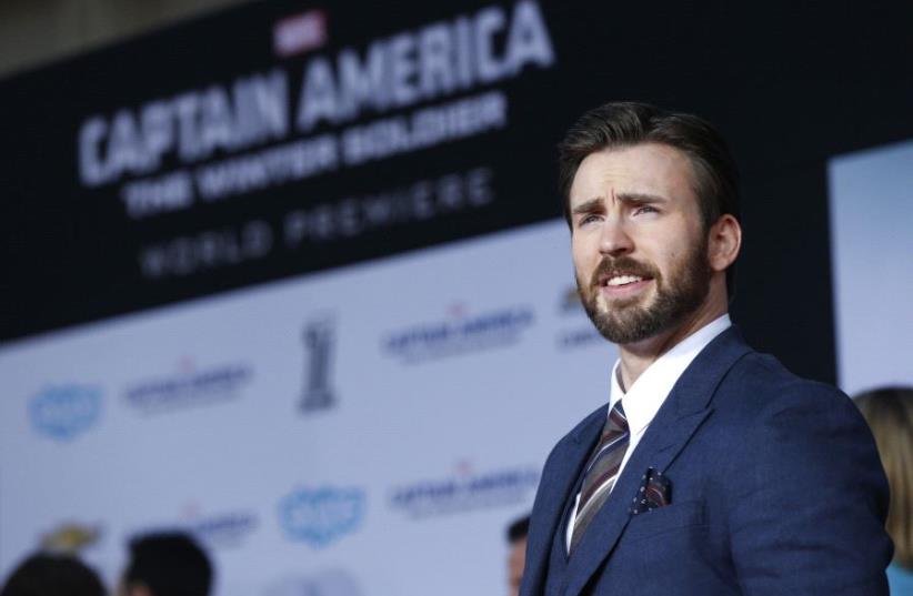 Chris Evans poses at the premiere of "Captain America: The Winter Soldier" at El Capitan theatre in Hollywood, California (photo credit: REUTERS)