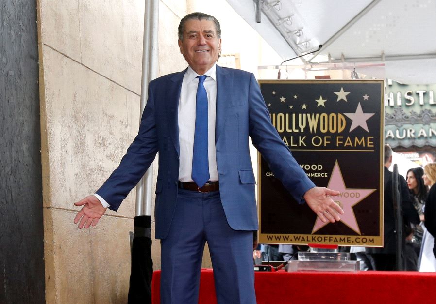 Israeli - American producer Haim Saban poses on his star after it was unveiled on the Hollywood Walk of Fame March 22 2017.  