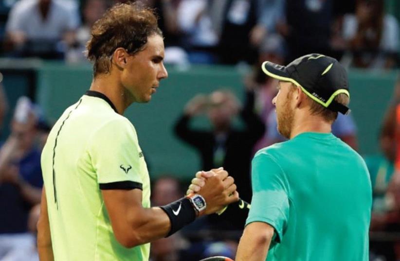 ISRAEL’S DUDI SELA (right) shakes hands with Rafael Nadal after the Spaniard beat him 6-3, 6-4 on Friday in second-round action at the Miami Open (photo credit: REUTERS)