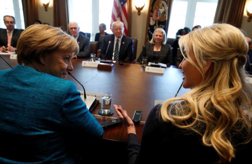 Germany's Chancellor Angela Merkel (L) and Ivanka Trump speak during a roundtable discussion between U.S. President Donald Trump and German and U.S. business leaders on vocational training at the White House in Washington, March 17, 2017 (photo credit: REUTERS)