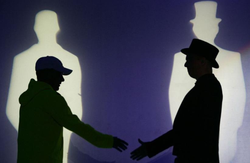 Chris Lowe (L) and Neil Tennant of the British duo "Pet Shop Boys" perform during a concert (photo credit: REUTERS)