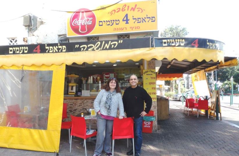 Sharon Hoffer (left) and owner Motti Margi outside Falafel B’4 Te’amim (photo credit: ITZIK NOI)