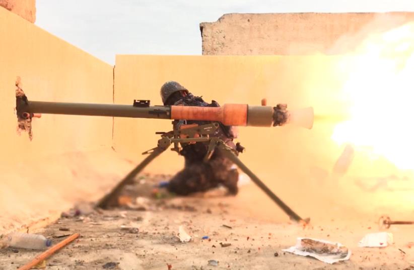 Soldier firing at ISIS targets in northern Iraq (photo credit: SETH J. FRANTZMAN)