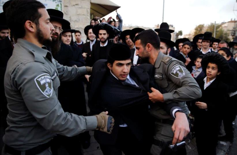Ultra-Orthodox Jews take part in a demonstration against members of their community serving in the Israeli army in Jerusalem (photo credit: REUTERS)