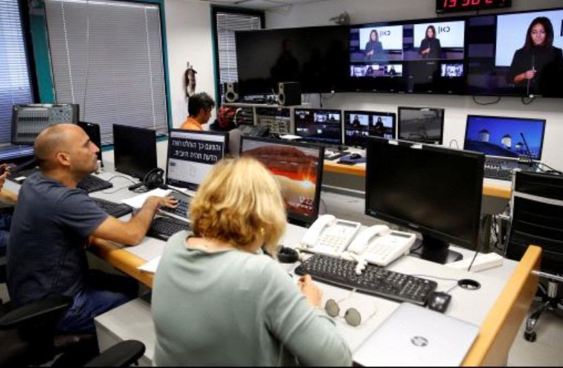 FILE PHOTO: Employees work in the offices of Kan, the new Israeli Public Broadcasting Corporation, in Tel Aviv, Israel November 3, 2016. (photo credit: REUTERS)