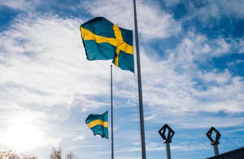 The Swedish flag [Illustrative] (photo credit: JONATHAN NACKSTRAND/AFP)