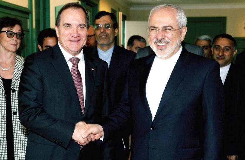SWEDEN’S PRIME MINISTER Stefan Lofven welcomes Iran’s Foreign Minister Mohammad Javad Zarif at Rosenbad in Stockholm, Sweden last year. (photo credit: REUTERS)