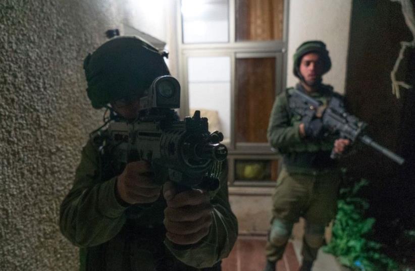 Israeli forces raid village of terrorist who killed IDF soldier  (photo credit: IDF SPOKESPERSON'S UNIT)