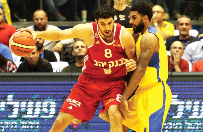 Hapoel Jerusalem forward Lior Eliyahu (left) will play against D.J. Seeley (right) Maccabi Tel Aviv on Saturday night after being suspended from one training session this week following a clash with the coaching staff. (photo credit: ADI AVISHAI)