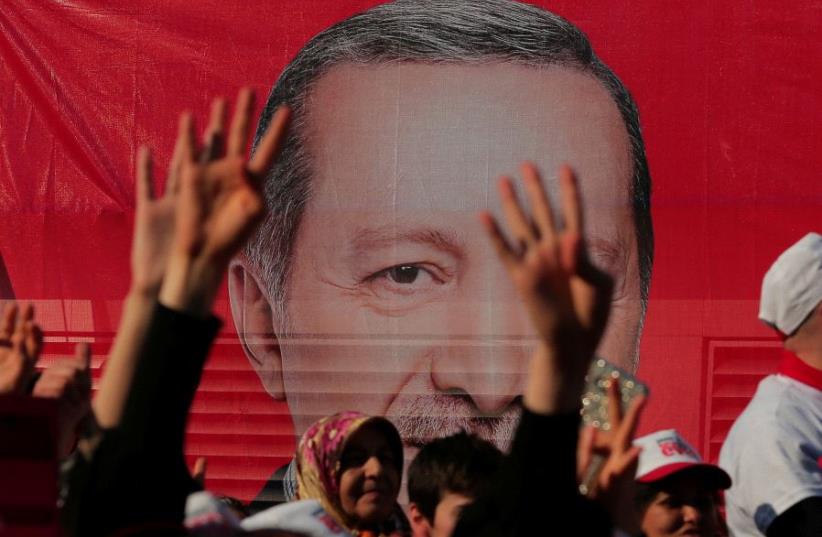 Supporters listen to the speech by Turkish President Tayyip Erdogan during a rally for the upcoming referendum in Istanbul, Turkey (photo credit: REUTERS)