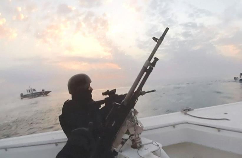 An image taken from a video shows Bahraini forces raiding a speedboat manned by Shi’ite fugitives it says were heading for Iran from Bahrain’s northeastern coast in February (photo credit: REUTERS)