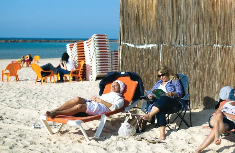 Tourists from France France sit on the beach in Netanya (photo credit: REUTERS)