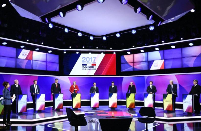 The eleven French presidential election candidates take part in a special political television show entitled "15min to Convince" at the studios of French Television channel France 2 in Saint-Cloud, near Paris (photo credit: REUTERS)