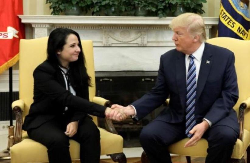  Aya Hijazi, an Egyptian-American woman detained in Egypt for nearly three years on human trafficking charges, meets with U.S. President Donald Trump in the Oval Office of the White House in Washington, US, April 21, 2017.  (photo credit: REUTERS)