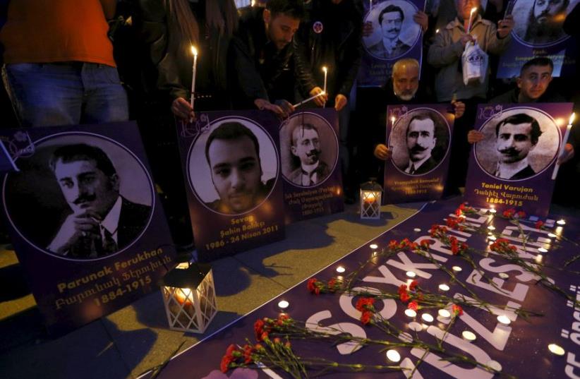 Demonstrators hold candles and pictures of Armenian victims during a commemoration for the victims of mass killings of Armenians by Ottoman Turks in the Armenian Genocide, in Istanbul April 23, 2015.  (photo credit: REUTERS)