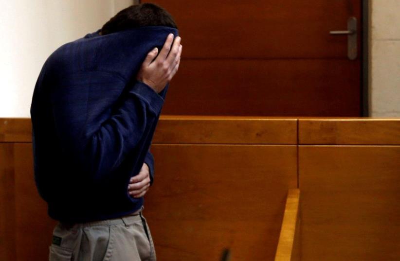 An US-Israeli teen who was arrested in Israel on suspicion of making bomb threats against Jewish community centers in the United States, Australia and New Zealand is seen at a remand hearing at Magistrate's Court in Rishon Lezion, Israel on March 23, 2017 (photo credit: REUTERS)