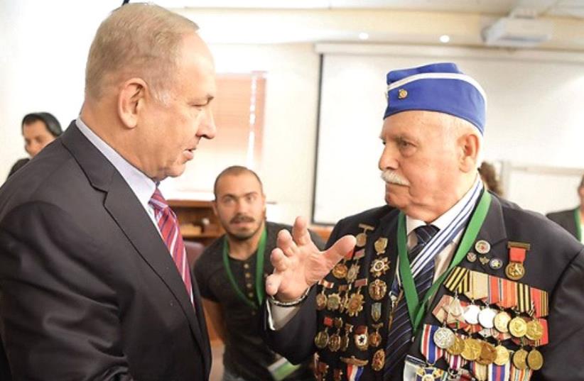 Prime Minister Benjamin Netanyahu with Holocaust survivor Max Privler, who climbed out of a mass murder pit and joined the Red Army (photo credit: AMOS BEN-GERSHOM/GPO)