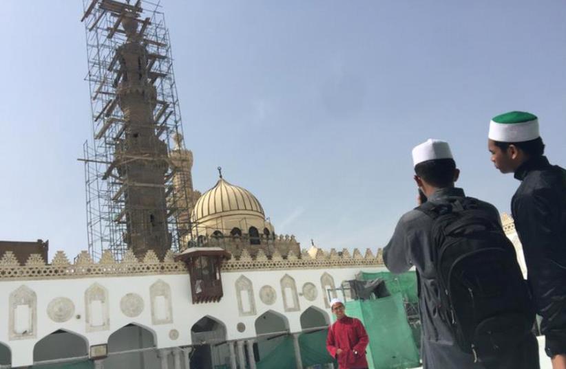 Students take pictures at Al-Azhar mosque as restoration work is conducted ahead of Pope Francis’s visit, in Cairo on Wednesday . (photo credit: REUTERS)