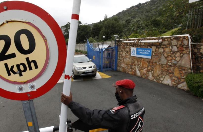 A security guard keeps watch at the entrance of King David School High School in suburban Johannesburg, March 15, 2012. (photo credit: SIPHIWE SIBEKO/REUTERS)