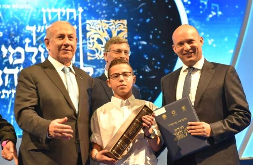 Prime Minister Benjmain Netanyahu and Education Minister Naftali Bennett with bible quiz winner Sagiv Lugasi (photo credit: SHLOMI AMSALLEM)
