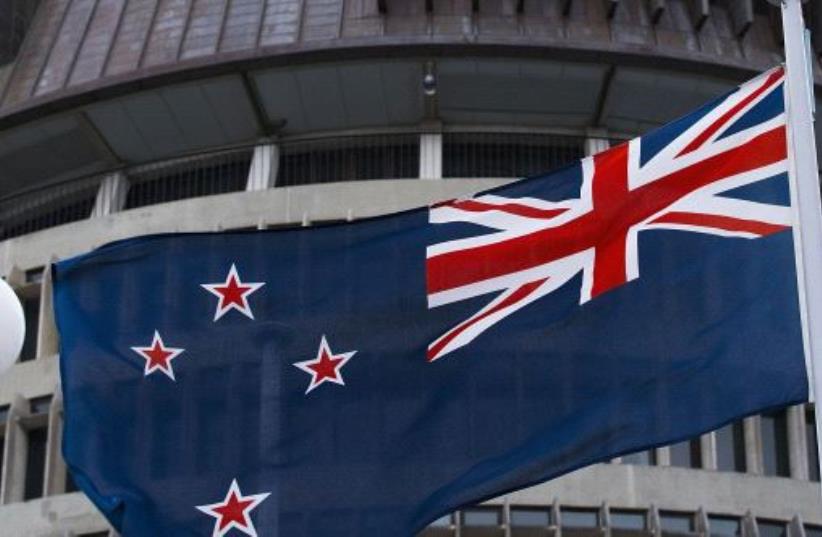 The current New Zealand flag flies on Parliament buildings in Wellington's Central Cusiness District on March 24, 2016. (photo credit: AFP PHOTO)