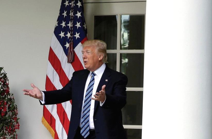 US PRESIDENT Donald Trump gestures to the press (photo credit: REUTERS)