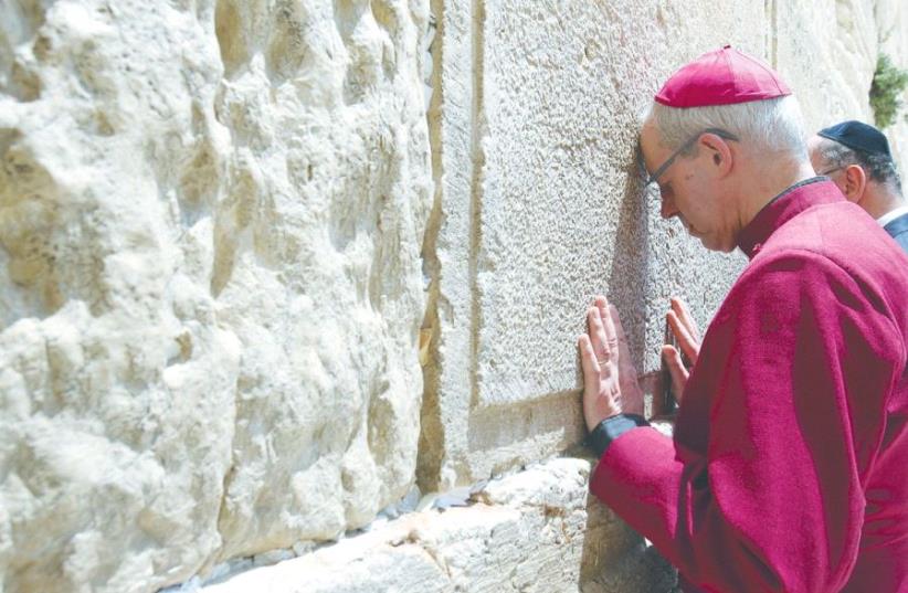 ARCHBISHOP OF CANTERBURY Justin Welby prays at the Western Wall. (photo credit: MARC ISRAEL SELLEM/THE JERUSALEM POST)
