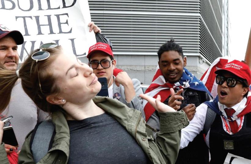 AN ANTI-TRUMP demonstrator interacts with pro-Trump supporters near the Intrepid Sea, Air & Space Museum in New York ahead of an expected visit by the president earlier this month (photo credit: REUTERS)
