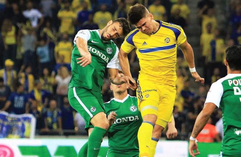Maccabi Tel Aviv striker Vidar Orn Kjartansson (in yellow) netted his team’s opener in last night’s 2-0 win over Maccabi Haifa at Haifa Stadium. (photo credit: ERAN LUF)
