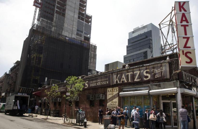People stand in line at Katz's Delicatessen, the famous deli founded in 1888, in New York's lower East Side (photo credit: REUTERS)
