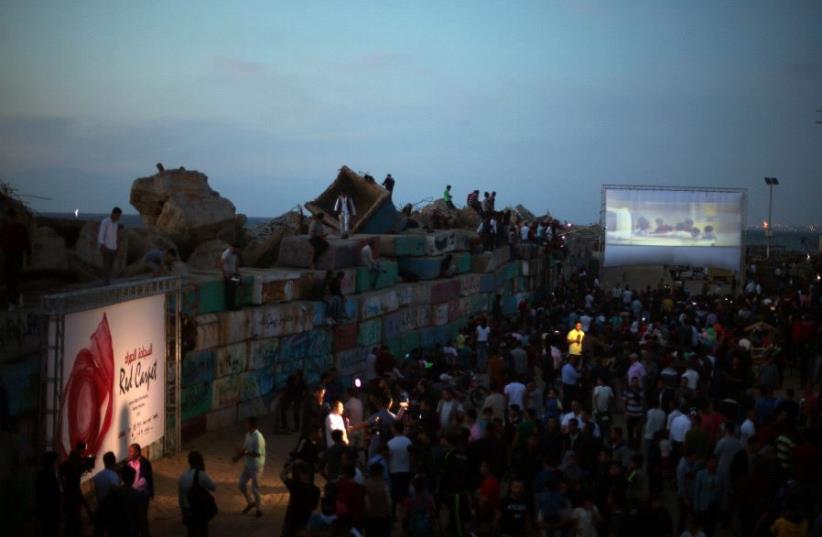 A film is screened during the third edition of the Red Carpet Film Festival, at the seaport of Gaza City May 12, 2017. (photo credit: REUTERS)