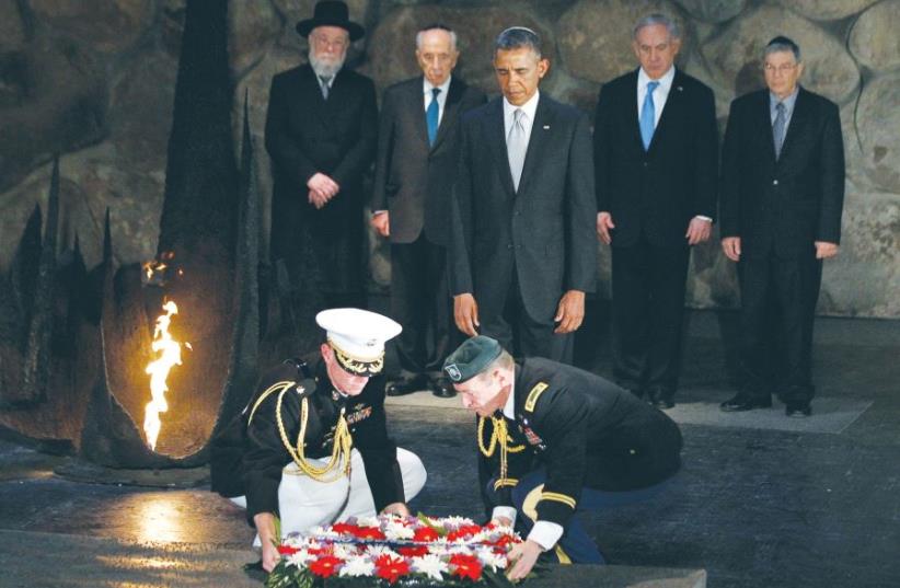 THEN-US PRESIDENT Barack Obama participates in a wreath laying ceremony in the Hall of Remembrance during his visit to Yad Vashem in Jerusalem on March 22, 2013. Pictured behind Obama are, from left, Chief Rabbi Meir Lau, then-president Shimon Peres, Prime Minister Benjamin Netanyahu and Yad Vashem  (photo credit: REUTERS)