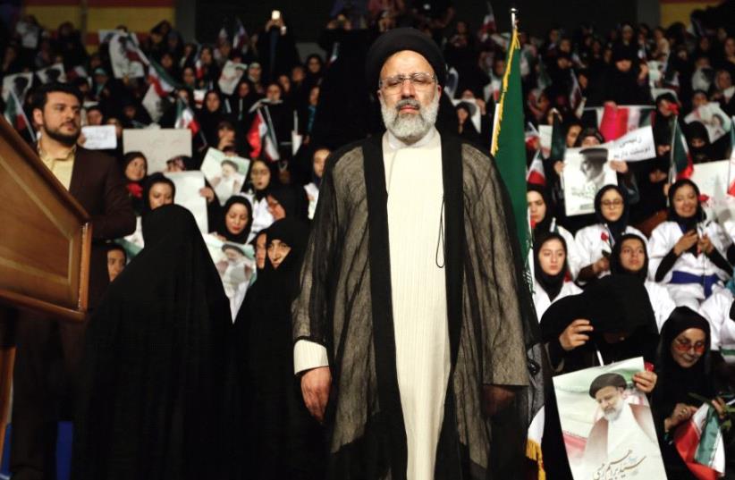Iranian presidential candidate Ebrahim Raisi attends a campaign rally in Tehran, April 29 (photo credit: ATTA KENARE / AFP)