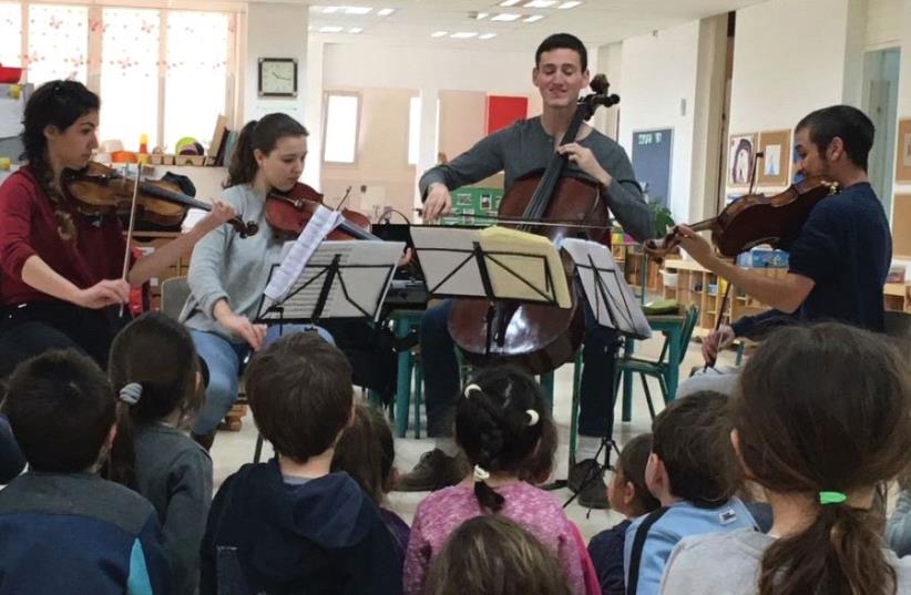 Musethica musicians play in front of a group of kindergarten children in Kibbutz Ramot Menashe in the North (photo credit: MUSETHICA)