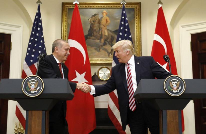 Turkey's President Recep Tayyip Erdogan (L) shakes hands with US President Donald Trump as they give statements to reporters in the Roosevelt Room of the White House in Washington, US May 16, 2017.  (photo credit: REUTERS)