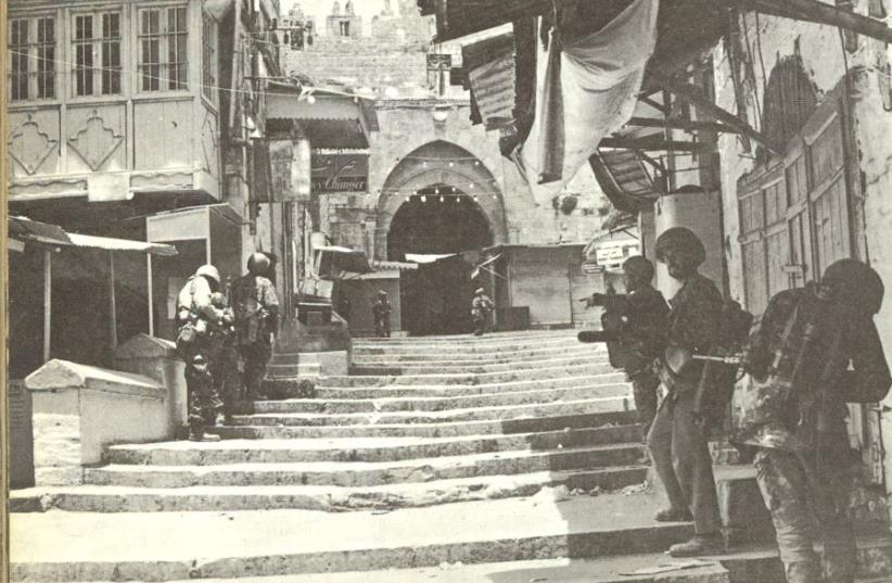 Advancing in the Old City near Herod’s Gate. The shutters were all closed and behind some, snipers lay in wait (photo credit: BAMAHANE/IDF WEEKLY JUNE 12 1967 ISSUE)