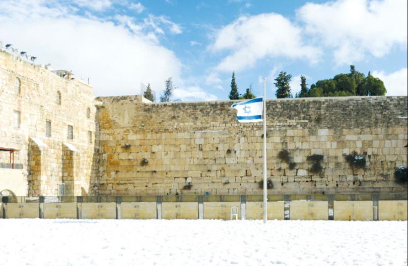 The Western Wall on a rare snowy day in 2013 (photo credit: HAIM ZACH/GPO)
