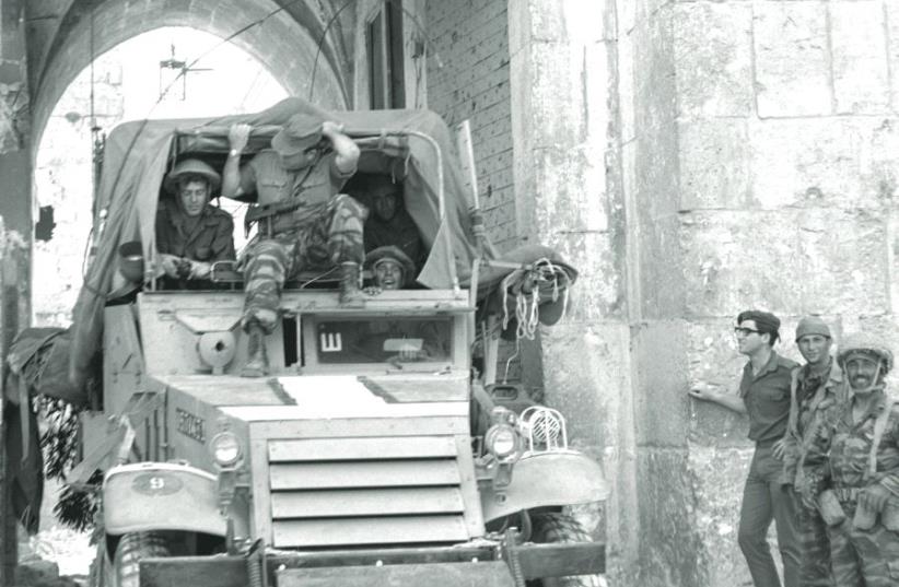 An IDF armored car passes through the Lions’ Gate in the Old City of Jerusalem on June 7, 1967 (photo credit: ILAN BRUNER/GPO)