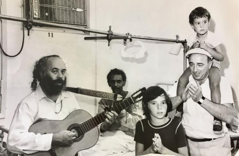 Simcha Holtzberg visted hospitals and rehabilitation centers weekly. Here, around the time of the Six Day War, he visits the sick alongside Rabbi Shlomo Carlebach (photo credit: EPHRAIM ERDE)