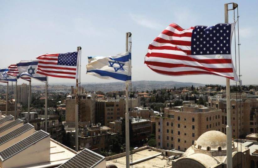 Israeli and US flags flutter atop the King David Hotel in Jerusalem, in preparation for US President Donald Trump’s arrival (photo credit: RONEN ZVULUN/REUTERS)