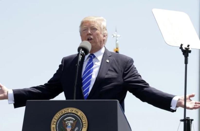 President Donald Trump addresses the graduating class of the US Coast Guard Academy in New London, Connecticut. (photo credit: KEVIN LAMARQUE/REUTERS)