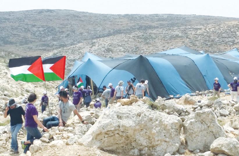 PROTESTERS PITCH tents in the West Bank over the weekend, rebuilding what they claimed was a former Arab village on the site. (photo credit: MAX SCHINDLER)