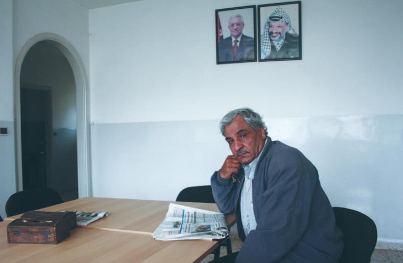 AWNI AL-MASHNI sits in his office in Ramallah earlier this month. (photo credit: UDI SHAHAM)