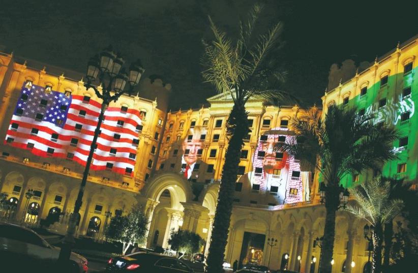 IMAGES of US President Donald Trump and Saudi Arabian King Salman bin Abdulaziz Al Saud are projected Saturday on the front of the Ritz-Carlton, where Trump was staying in Riyadh (photo credit: REUTERS)