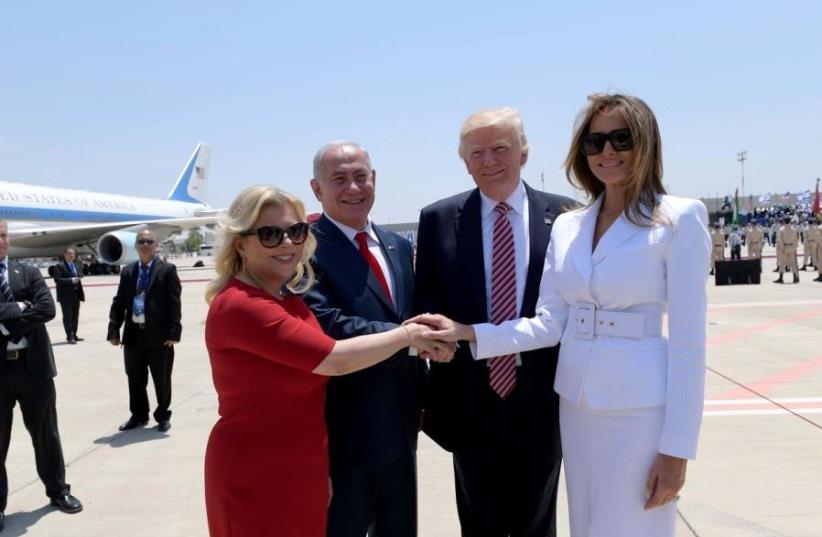 Prime Minister Benjamin Netanyahu and his wife, Sara, (L) greet US President Donald Trump and First Lady Melania Trump at Israel's Ben-Gurion Airport, May 22, 2017 (photo credit: AVI OHAYON - GPO)