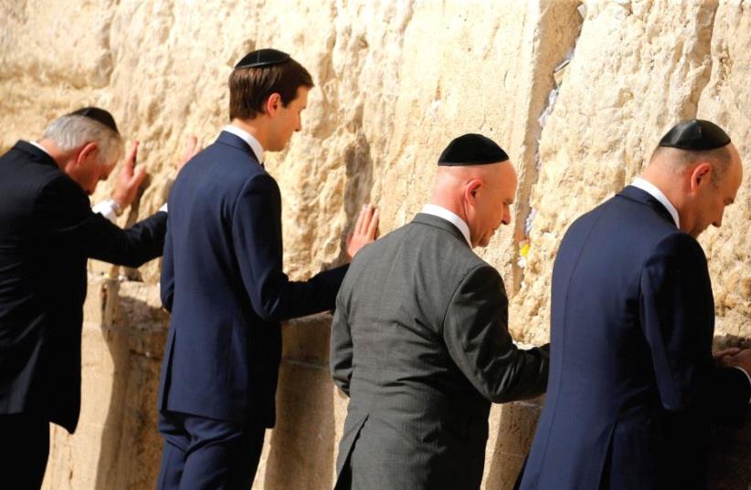 US SECRETARY of State Rex Tillerson (from left), White House senior adviser Jared Kushner, National Security Adviser H.R. McMaster and chief economic adviser Gary Cohn leave notes at the Western Wall. (photo credit: REUTERS)