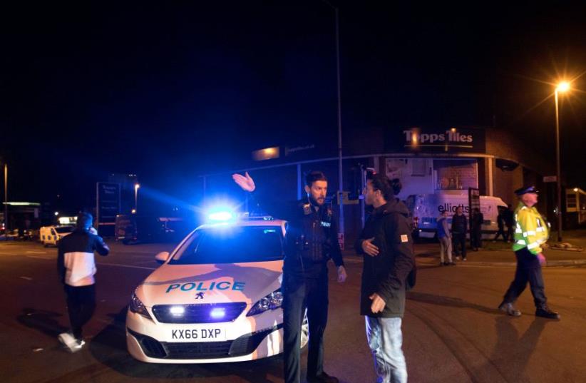 Police set up a cordon outside the Manchester Arena in northern England where U.S. singer Ariana Grande had been performing in Manchester, Britain (photo credit: REUTERS)